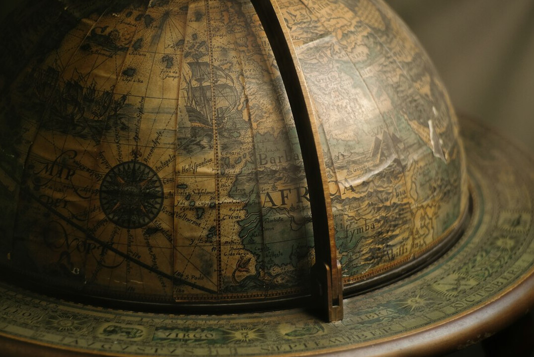 Antique magnifying glass resting on an old map