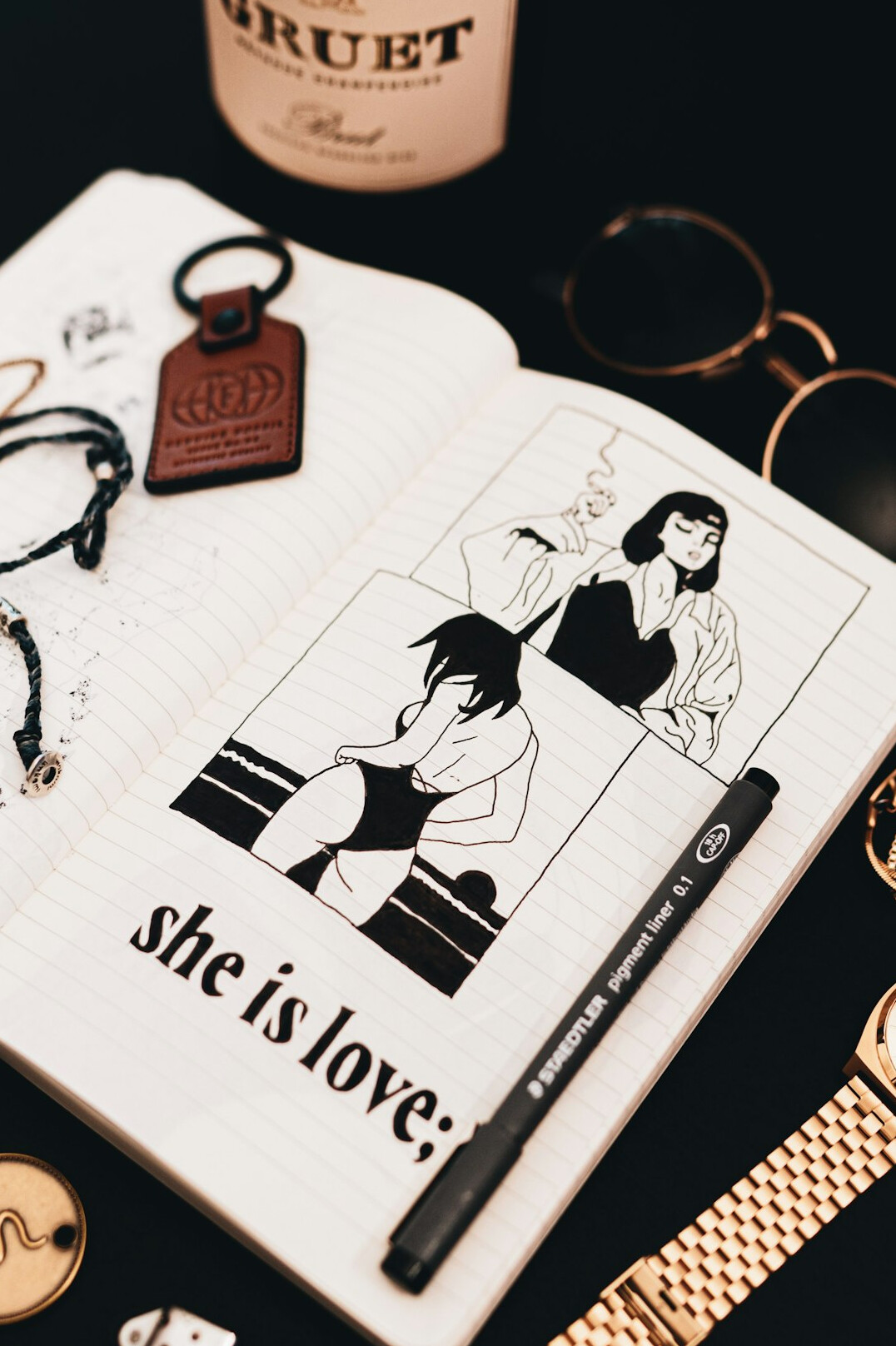 Open notebook with handwritten notes and a magnifying glass