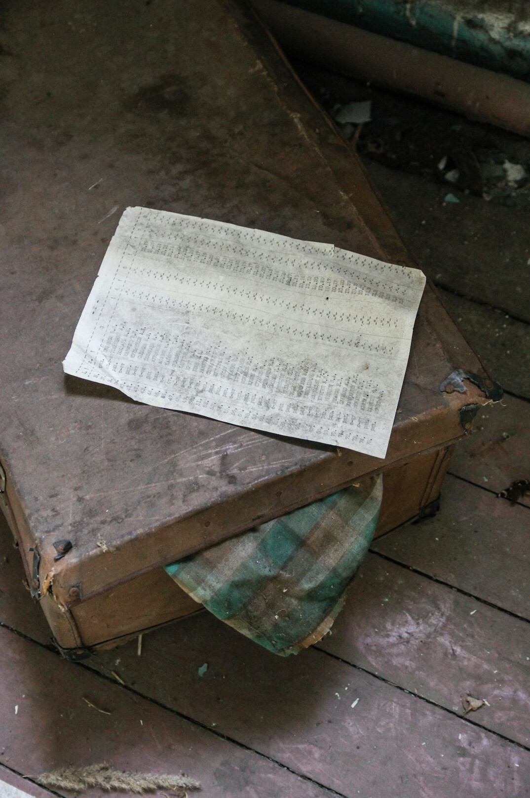 Open case file folder with newspaper clippings and photographs on a desk